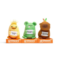 Three crochet plush toys standing together: yellow duck, green frog, brown bear