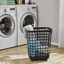 Black rolling laundry hamper holding folded towels on caster wheels
