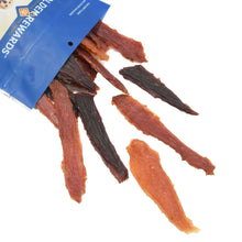 Assorted chicken, duck, and beef dog jerky sticks spilling from a Golden Rewards bag