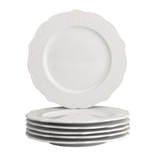 White porcelain side plate with embossed dahlia floral pattern around the rim