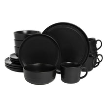 Matte black dinnerware set: stacked dinner plates, bowls, and handled mugs with smooth rims
