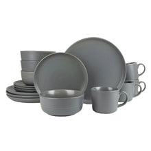 Matte gray stoneware dinnerware set with plates, bowls, and mugs, stacked