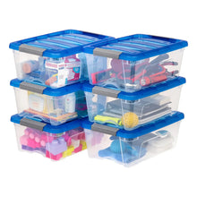 Stacked translucent storage bins with blue buckle lids and clear bases holding assorted items