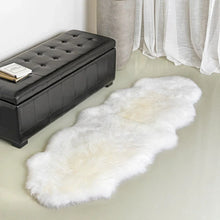 White sheepskin rug with fluffy pile and long oval shape on the floor
