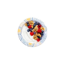 Disposable paper bowl with granola and mixed berries, blue-and-gold patterned rim