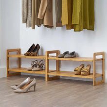 Bamboo 2-tier shoe rack with shoes on slatted shelves, light wood frame