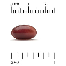 Maroon softgel capsule on a measuring scale