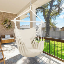 Beige hammock chair swing with hanging rope seat and two cushion pads