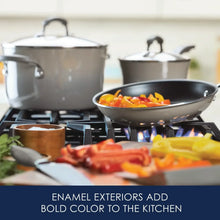 Gray hard enamel pots and skillet on stovetop with sliced vegetables