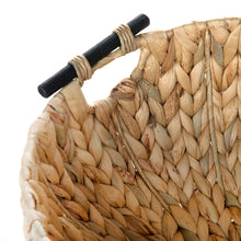 Close-up of woven water hyacinth decorative bowl with wooden-look handle bars