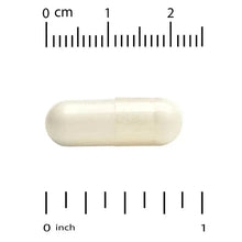 Biotin capsule next to inch and cm measurement scale.
