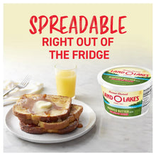 Salted whipped butter tub next to toast and a glass