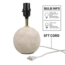 Mini table lamp with textured ball base, brass stem, black socket, and power cord