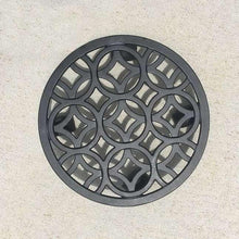 Black round plant caddy with decorative lattice insert and small caster feet