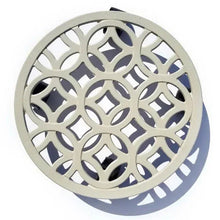 Off-white round plant caddy with circular lattice pattern and raised rim