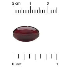 Red-brown DHA softgel capsule on measurement scale