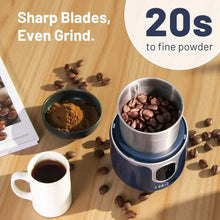 Blue cordless electric grinder with open stainless chamber holding coffee beans