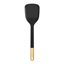 Black silicone turner spatula with rounded head and gold handle end