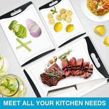 Set of white plastic cutting boards with black handles; foods arranged on surfaces