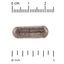 Dark purple supplement capsule horizontally with measurement scale