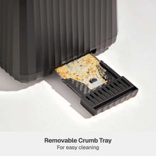 Slate grey toaster with removable crumb tray pulled out and crumbs visible
