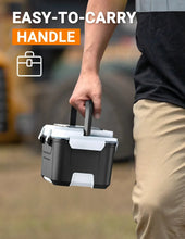 Black heated lunch box with easy-carry handle held by a person outdoors