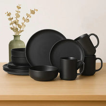 Matte black stoneware dinnerware set with dinner plates, salad bowls, and mugs