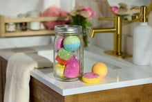 Wide-mouth glass jar with metal lid, filled with colorful candies and small treats