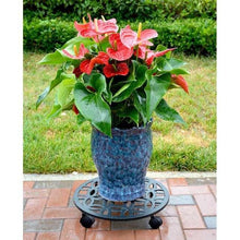 Black plant caddy with lattice top under a blue planter with flowers