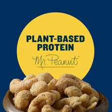 Plant-based protein cashews in a bowl with cashews piled in front of a yellow label