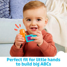 MEGA Bloks ABC letter block train toy in a child’s hands on a couch