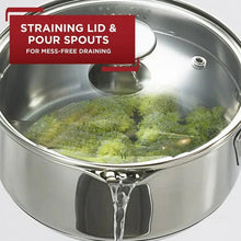 Stainless steel straining lid with pour spouts over a pot for draining