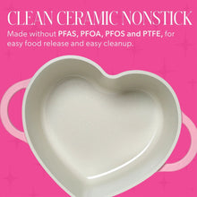 Heart-shaped Dutch oven lid interior view in light cream ceramic with pink rim