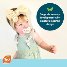 RaZberry silicone teether toy, cream pacifier-style with red textured bumps.