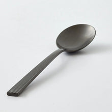 Black stainless steel serving spoon with ridged handle