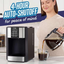 Programmable coffee maker as a person pours coffee from the carafe