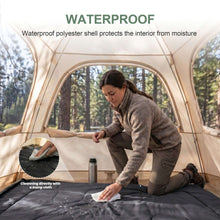 Double sleeping bag laid out while a person wipes the outer fabric