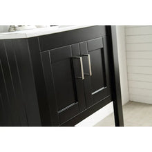 Black bathroom vanity with paneled doors and brushed metal bar pulls.