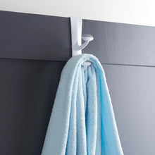 White over-the-door rubber grip hook holding a light blue towel