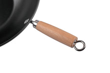 Black wok pan with light wood handle and metal hanging loop