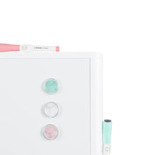 Dry erase whiteboard corner with round magnets and teal dry-erase marker