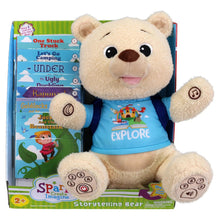 Plush storytelling bear with blue Explore shirt beside illustrated storybooks in box