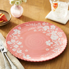Pink floral melamine dinner plate with white blossoms and swirling center design