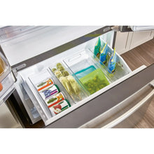 Clear kitchen bin in a drawer with green produce and snack packages