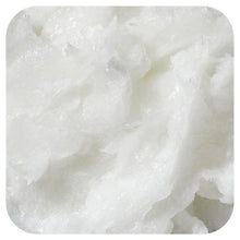 Solid coconut oil texture, pale white flakes in close-up.