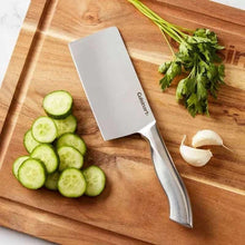 Stainless steel cleaver knife with white handle and angled blade near sliced cucumber