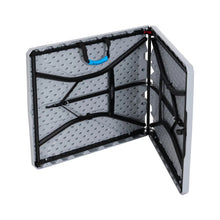 Gray folding table with open folding frame and gridded panels, underside view.