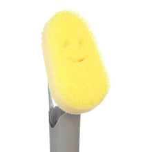 Yellow non-scratch foam sponge head on gray dish wand