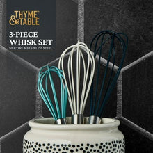 Three silicone whisks in ceramic crock, stainless handles with teal, white, dark loops