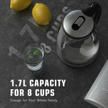 Electric glass kettle with black handle, spout opening, and stainless steel base